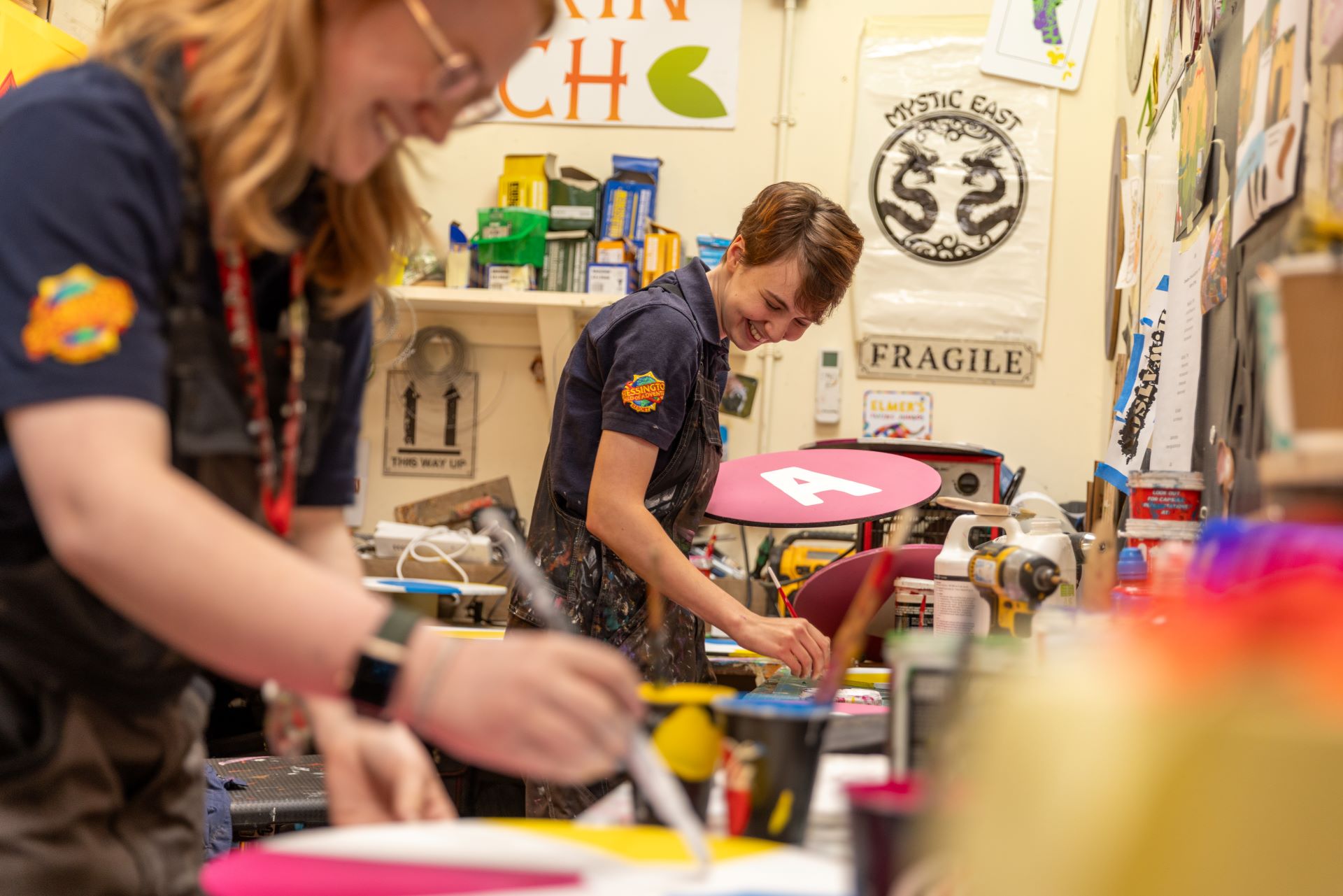 Chessington World of Adventures Resort staff members painting wall signs