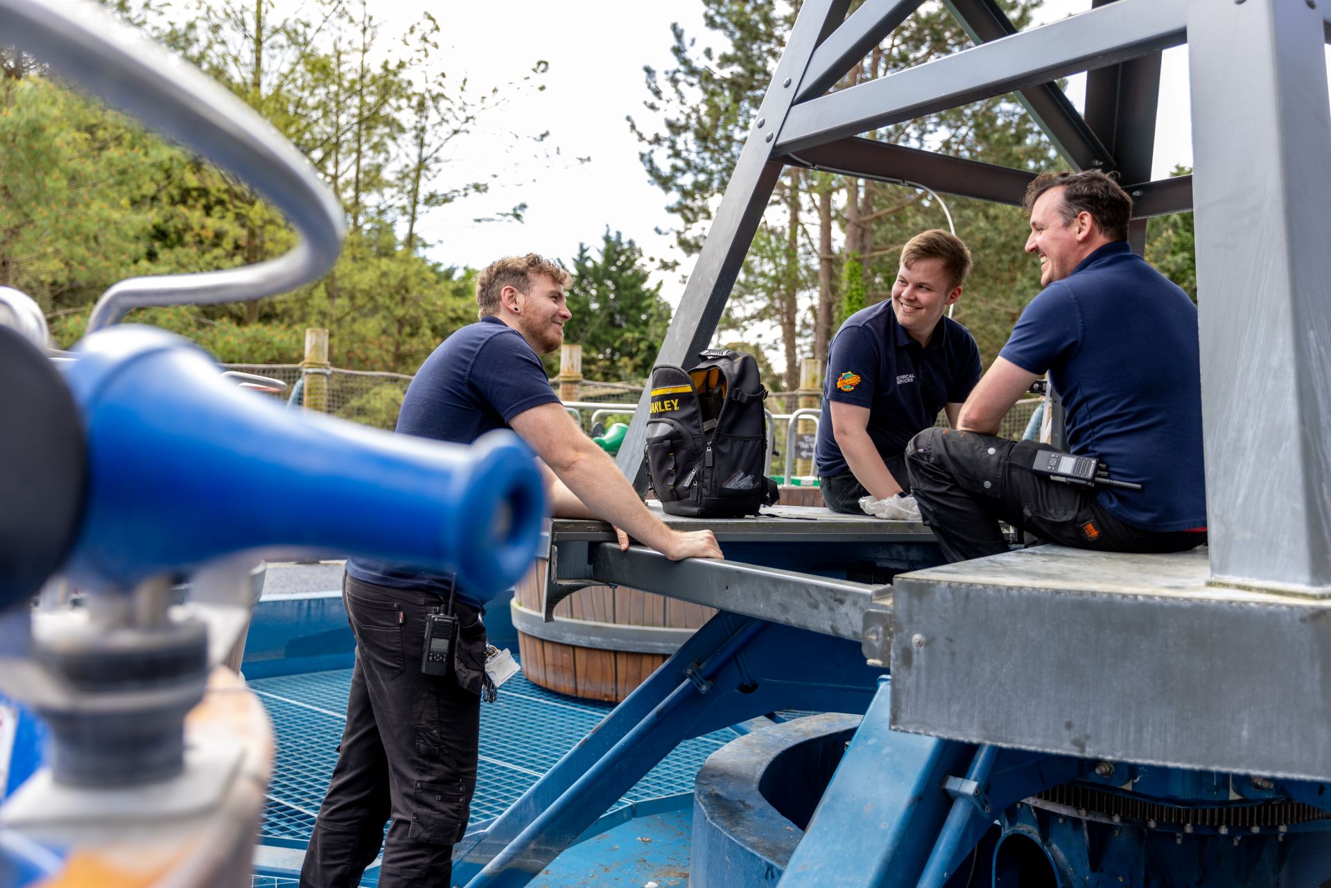 Three Chessington World of Adventures maintenance staff members smiling 