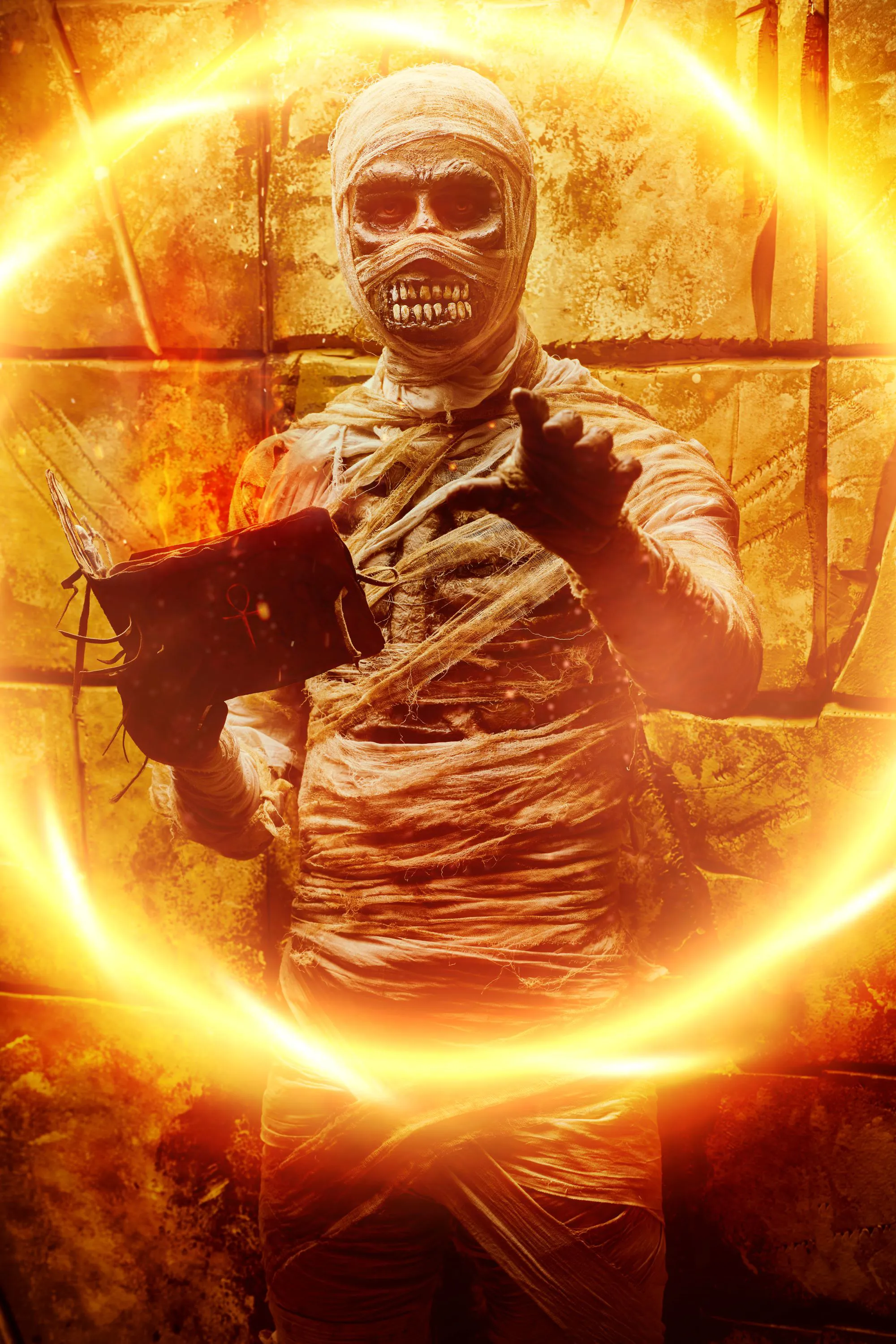 A mummy in a dungeon with a tattered spell book and an orange glowing spell
