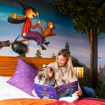 Family reading in a Room on the Broom hotel room in the Chessington Safari Hotel