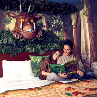 Family reading in a Gruffalo themed hotel room in the Chessington Safari Hotel