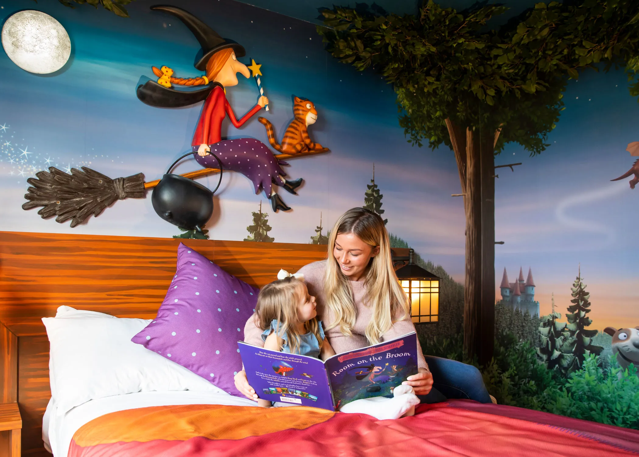 Family reading in a Room on the Broom hotel room in the Chessington Safari Hotel